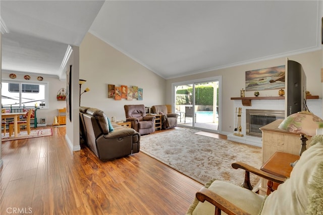 1428 N Erin Ave, Upland, CA 91786 - living area featuring crown molding, wood finished floors, a glass covered fireplace, and lofted ceiling