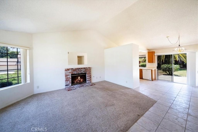 42205 Rubicon Cir, Temecula, CA 92591 - unfurnished living room with lofted ceiling, a fireplace, light tile patterned flooring, and light colored carpet
