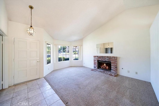 42205 Rubicon Cir, Temecula, CA 92591 - foyer entrance featuring vaulted ceiling, light colored carpet, light tile patterned floors, and a fireplace
