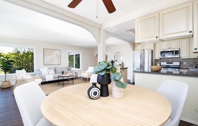 2535 Jefferson St Unit 10, Carlsbad, CA 92008 - dining area featuring a ceiling fan, arched walkways, and dark wood-style flooring