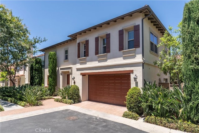 320 Bronze, Irvine, CA 92618 - view of front of home with stucco siding, a garage, and driveway