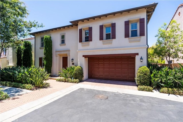 320 Bronze, Irvine, CA 92618 - mediterranean / spanish house featuring stucco siding, a garage, and driveway