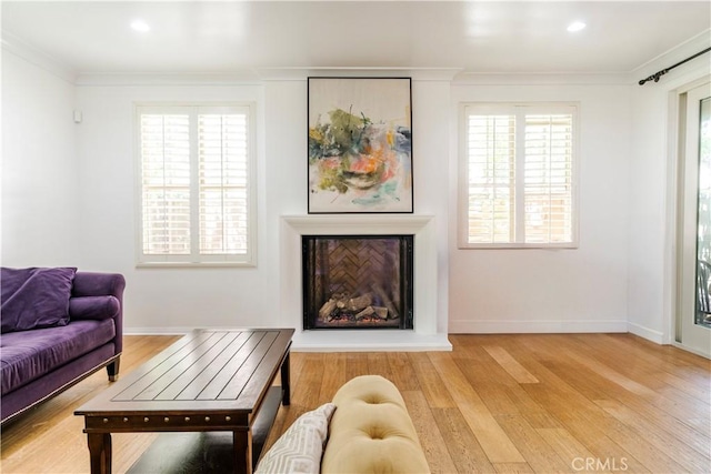 320 Bronze, Irvine, CA 92618 - living area with ornamental molding, a fireplace with raised hearth, light wood finished floors, plenty of natural light, and recessed lighting
