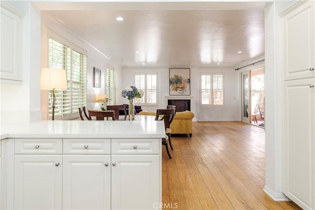 320 Bronze, Irvine, CA 92618 - kitchen with a peninsula, light wood-style floors, light countertops, a fireplace, and recessed lighting