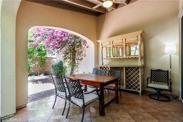 320 Bronze, Irvine, CA 92618 - dining room with ceiling fan, a high ceiling, arched walkways, tile patterned flooring, and a wooden ceiling with exposed beams