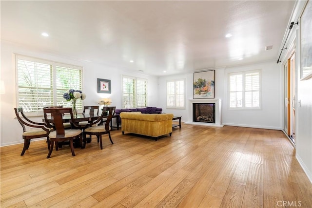 320 Bronze, Irvine, CA 92618 - living area featuring light wood finished floors, healthy amount of natural light, a fireplace with raised hearth, and recessed lighting