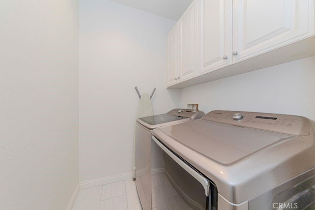1133 Maag Pl Unit 107, Fullerton, CA 92833 - laundry room with washing machine and dryer, cabinet space, and light tile patterned floors