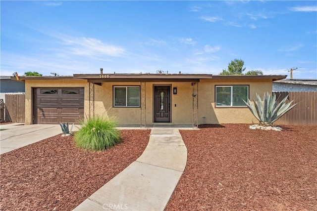 1446 Morgan Rd, San Bernardino, CA 92407 - ranch-style house with stucco siding, an attached garage, and driveway