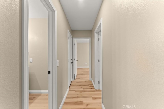 1446 Morgan Rd, San Bernardino, CA 92407 - hallway with light wood-style flooring and baseboards