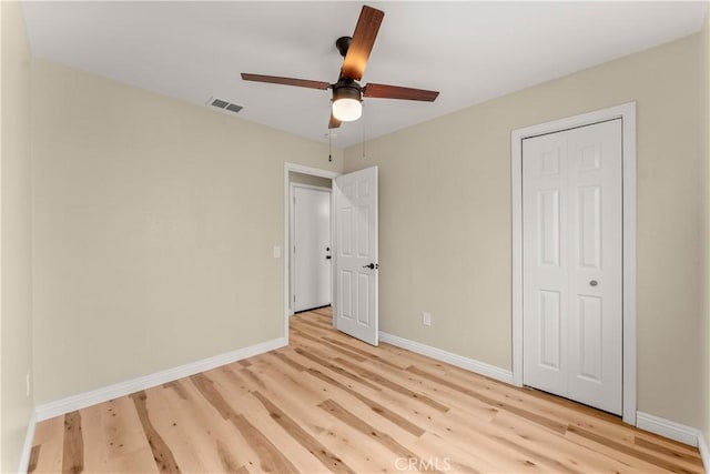 1446 Morgan Rd, San Bernardino, CA 92407 - unfurnished bedroom with light wood-style flooring, a closet, and a ceiling fan