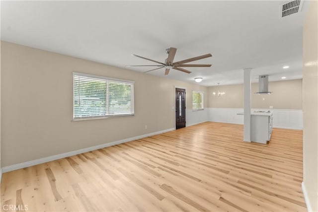 1446 Morgan Rd, San Bernardino, CA 92407 - unfurnished living room featuring ceiling fan, light wood-type flooring, a chandelier, wainscoting, and recessed lighting