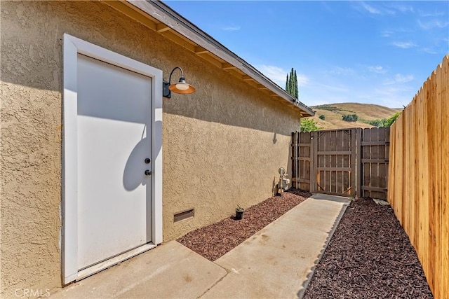 1446 Morgan Rd, San Bernardino, CA 92407 - doorway to property featuring stucco siding and a gate