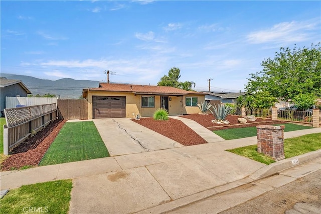 1446 Morgan Rd, San Bernardino, CA 92407 - single story home with concrete driveway, stucco siding, and an attached garage