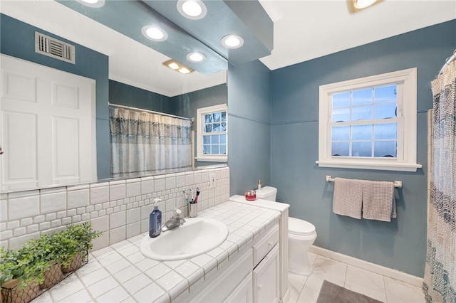 942 University Ave, Burbank, CA 91504 - bathroom with vanity, decorative backsplash, marble look tiles, and curtained shower