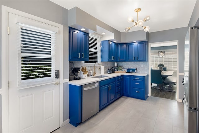 942 University Ave, Burbank, CA 91504 - kitchen featuring appliances with stainless steel finishes, blue cabinetry, a chandelier, and light countertops