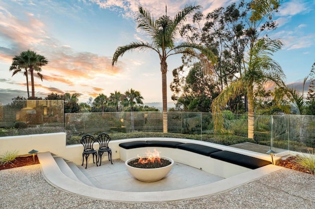 7888 Muirfield Way, Rancho Santa Fe, CA 92067 - pool at dusk featuring a fire pit and a patio