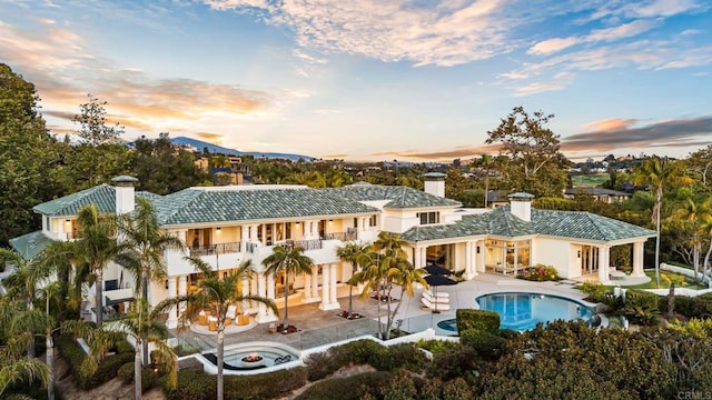 7888 Muirfield Way, Rancho Santa Fe, CA 92067 - back of house featuring a chimney, a balcony, a patio, and stucco siding