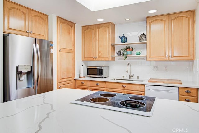 3179 Alta Vis Unit A, Laguna Woods, CA 92637 - kitchen featuring stainless steel appliances, light stone counters, recessed lighting, a skylight, and decorative backsplash