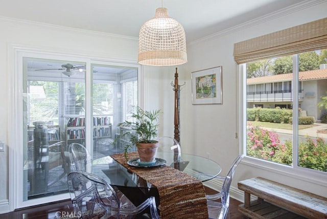3179 Alta Vis Unit A, Laguna Woods, CA 92637 - dining area with healthy amount of natural light, ornamental molding, wood finished floors, and a ceiling fan