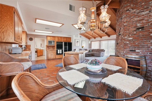 6020 Valley Sage Rd, Acton, CA 93510 - dining space with a chandelier, beam ceiling, high vaulted ceiling, light tile patterned floors, and a fireplace