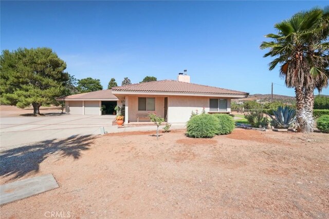 6020 Valley Sage Rd, Acton, CA 93510 - single story home with a chimney, stucco siding, a tiled roof, and concrete driveway