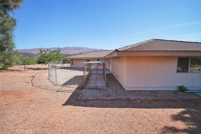 6020 Valley Sage Rd, Acton, CA 93510 - rear view of house featuring a mountain view, stucco siding, a tile roof, and a gate