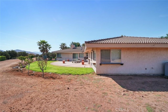 6020 Valley Sage Rd, Acton, CA 93510 - back of property featuring a patio area, stucco siding, a yard, a mountain view, and a tiled roof