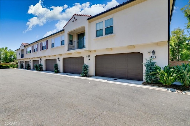 16 Agave, Lake Forest, CA 92630 - view of front facade with a garage, stucco siding, and a tile roof