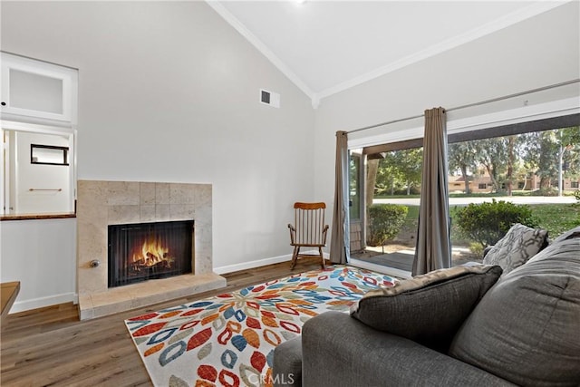 779 Via Sierra Nevada, Riverside, CA 92507 - living room with crown molding, a tiled fireplace, wood finished floors, and high vaulted ceiling