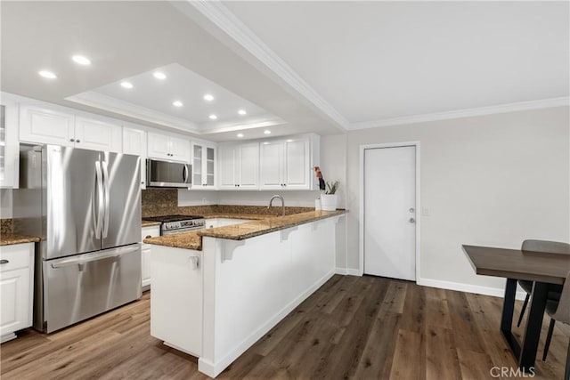 779 Via Sierra Nevada, Riverside, CA 92507 - kitchen with appliances with stainless steel finishes, ornamental molding, recessed lighting, a raised ceiling, and glass insert cabinets