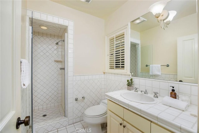 1129 Via Mirabel, Palos Verdes Estates, CA 90274 - full bathroom with vanity, a shower stall, tile patterned floors, a wainscoted wall, and tile walls