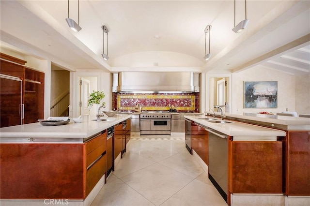 1129 Via Mirabel, Palos Verdes Estates, CA 90274 - kitchen featuring appliances with stainless steel finishes, a large island with sink, vaulted ceiling, modern cabinets, and tasteful backsplash
