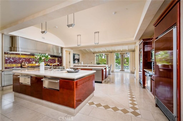 1129 Via Mirabel, Palos Verdes Estates, CA 90274 - kitchen featuring a warming drawer, a center island with sink, built in appliances, light tile patterned flooring, and light countertops
