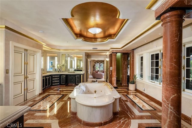 1129 Via Mirabel, Palos Verdes Estates, CA 90274 - bathroom with ornate columns, inlaid floor details, a raised ceiling, vanity, and marble tiled flooring