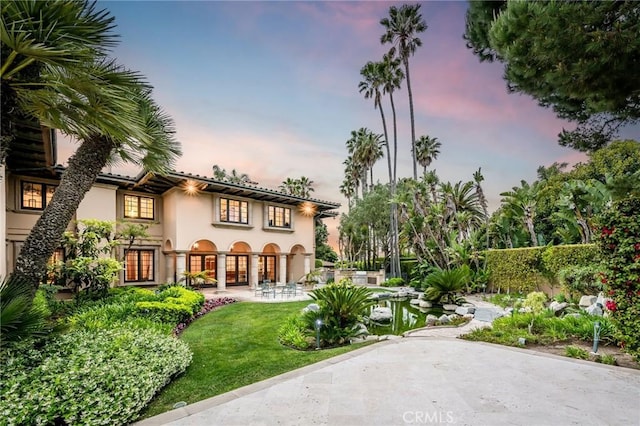 1129 Via Mirabel, Palos Verdes Estates, CA 90274 - back of property featuring stucco siding, a lawn, and a patio