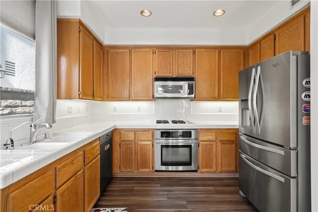 27545 Wellsley Way, Valencia, CA 91354 - kitchen featuring stainless steel appliances, dark wood-type flooring, tile counters, brown cabinetry, and recessed lighting