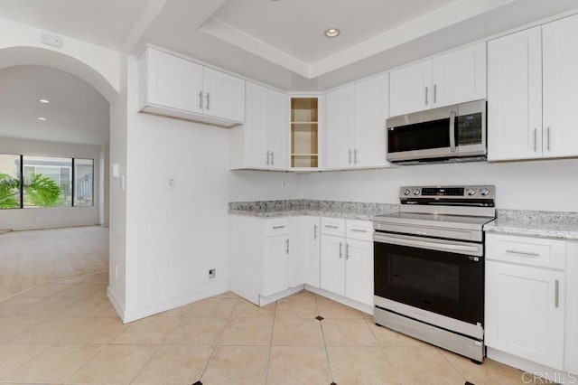 3414 Del Este Way, Oceanside, CA 92056 - kitchen with appliances with stainless steel finishes, light tile patterned flooring, white cabinetry, light stone countertops, and recessed lighting