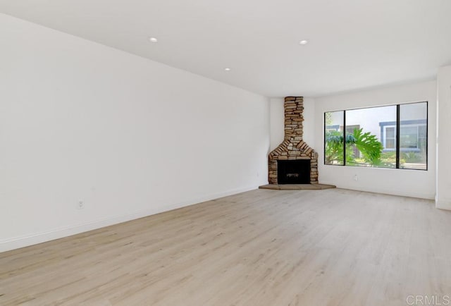 3414 Del Este Way, Oceanside, CA 92056 - unfurnished living room featuring light wood-style floors, recessed lighting, and a stone fireplace