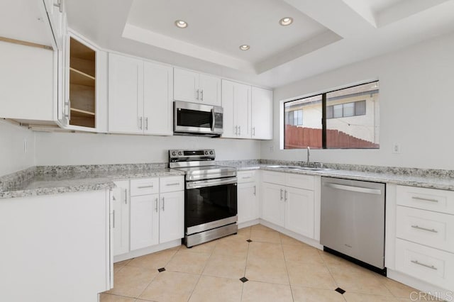 3414 Del Este Way, Oceanside, CA 92056 - kitchen with appliances with stainless steel finishes, a raised ceiling, recessed lighting, white cabinetry, and glass insert cabinets