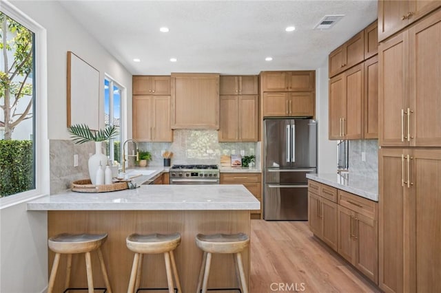 38 San Raphael, Dana Point, CA 92629 - kitchen featuring appliances with stainless steel finishes, custom exhaust hood, light countertops, healthy amount of natural light, and recessed lighting