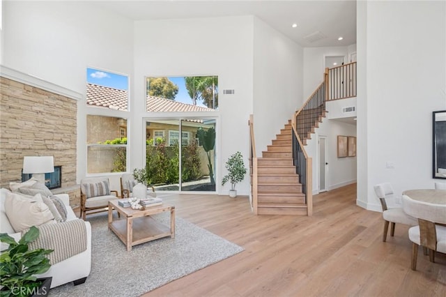 38 San Raphael, Dana Point, CA 92629 - living area with a high ceiling, light wood finished floors, stairway, a stone fireplace, and recessed lighting