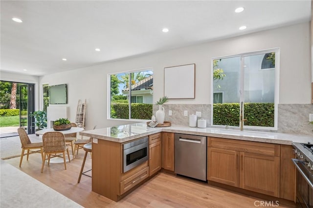 38 San Raphael, Dana Point, CA 92629 - kitchen with stainless steel appliances, healthy amount of natural light, light wood-type flooring, a peninsula, and recessed lighting