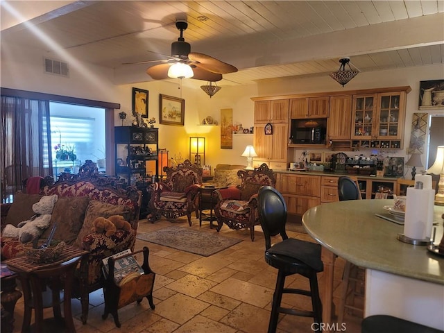 15845 La Vida Dr, Palm Springs, CA 92262 - dining room with stone tile flooring, ceiling fan, and a wooden ceiling with exposed beams