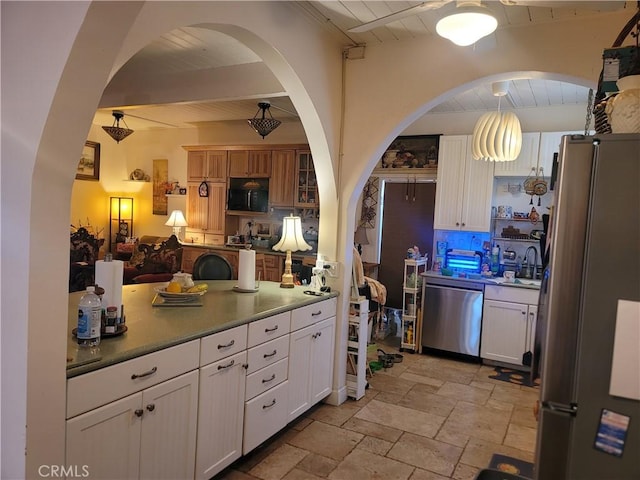 15845 La Vida Dr, Palm Springs, CA 92262 - kitchen featuring appliances with stainless steel finishes, stone tile floors, white cabinets, tasteful backsplash, and wood ceiling