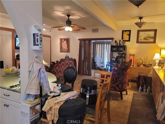 15845 La Vida Dr, Palm Springs, CA 92262 - dining room featuring stone tile flooring, a ceiling fan, and beamed ceiling
