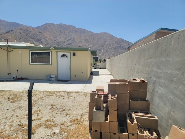 15845 La Vida Dr, Palm Springs, CA 92262 - view of front of property featuring a fenced backyard, a mountain view, and a patio area