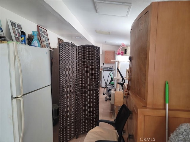 15845 La Vida Dr, Palm Springs, CA 92262 - kitchen with freestanding refrigerator, washer / dryer, and tile patterned flooring