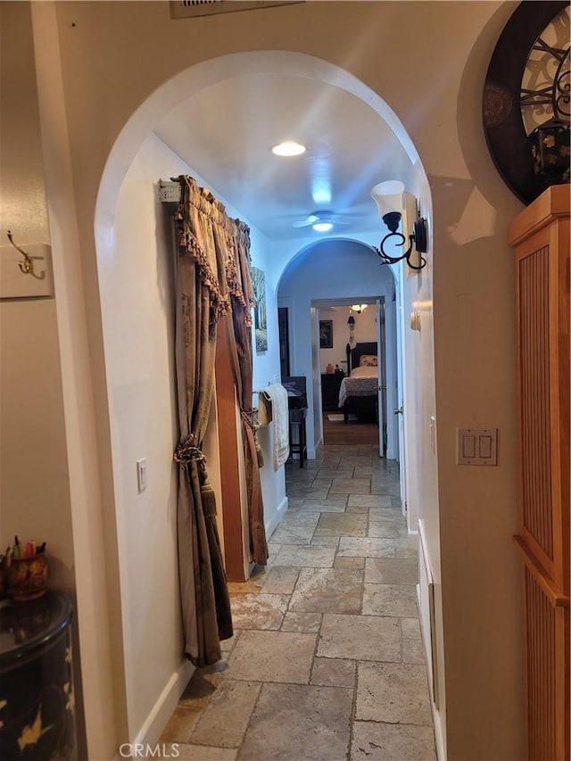 15845 La Vida Dr, Palm Springs, CA 92262 - hallway featuring stone tile floors and arched walkways