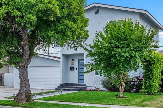21225 Kent Ave, Torrance, CA 90503 - view of front of home featuring stucco siding, an attached garage, a front yard, and concrete driveway