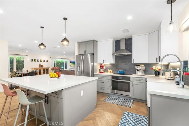 21225 Kent Ave, Torrance, CA 90503 - kitchen featuring stainless steel appliances, wall chimney exhaust hood, gray cabinets, plenty of natural light, and recessed lighting
